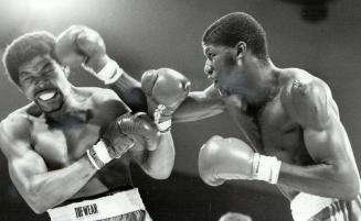 Take that! Cabbagetown Youth Centre's Terry Francis, right, connects to the head of Mark Johnson in their middleweight bout at the Harbor Castle Conve(...)