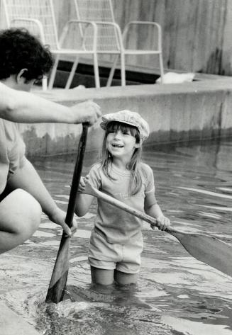 And Danielle Roy, 6 (right), takes a wet run before trying real paddling