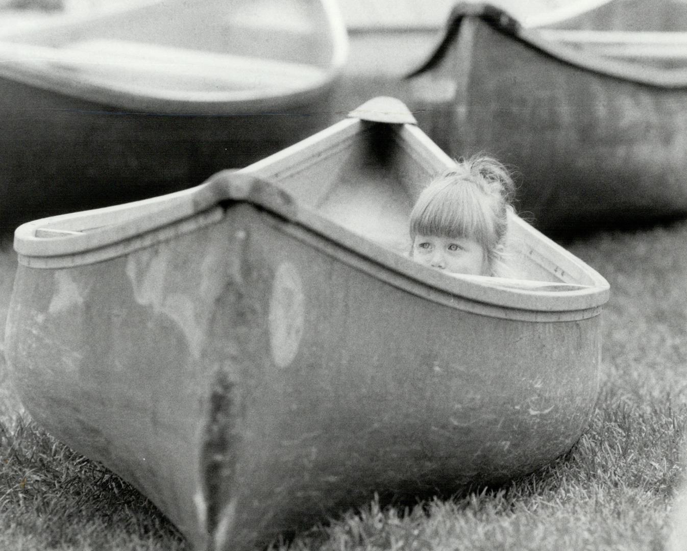 Carly Heming, aged 15 months, takes an inside view of one of the displays in Canoe Day at Harbourfront