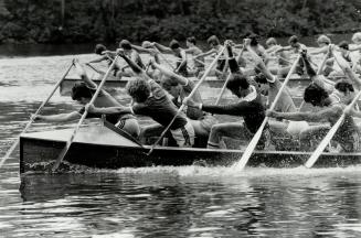 Together now. Mississauga Canoe Club paddlers pour it on in Dominion Day Regatta's juvenile war canoe race at Toronto Island. Nova Scotia crew won eve(...)