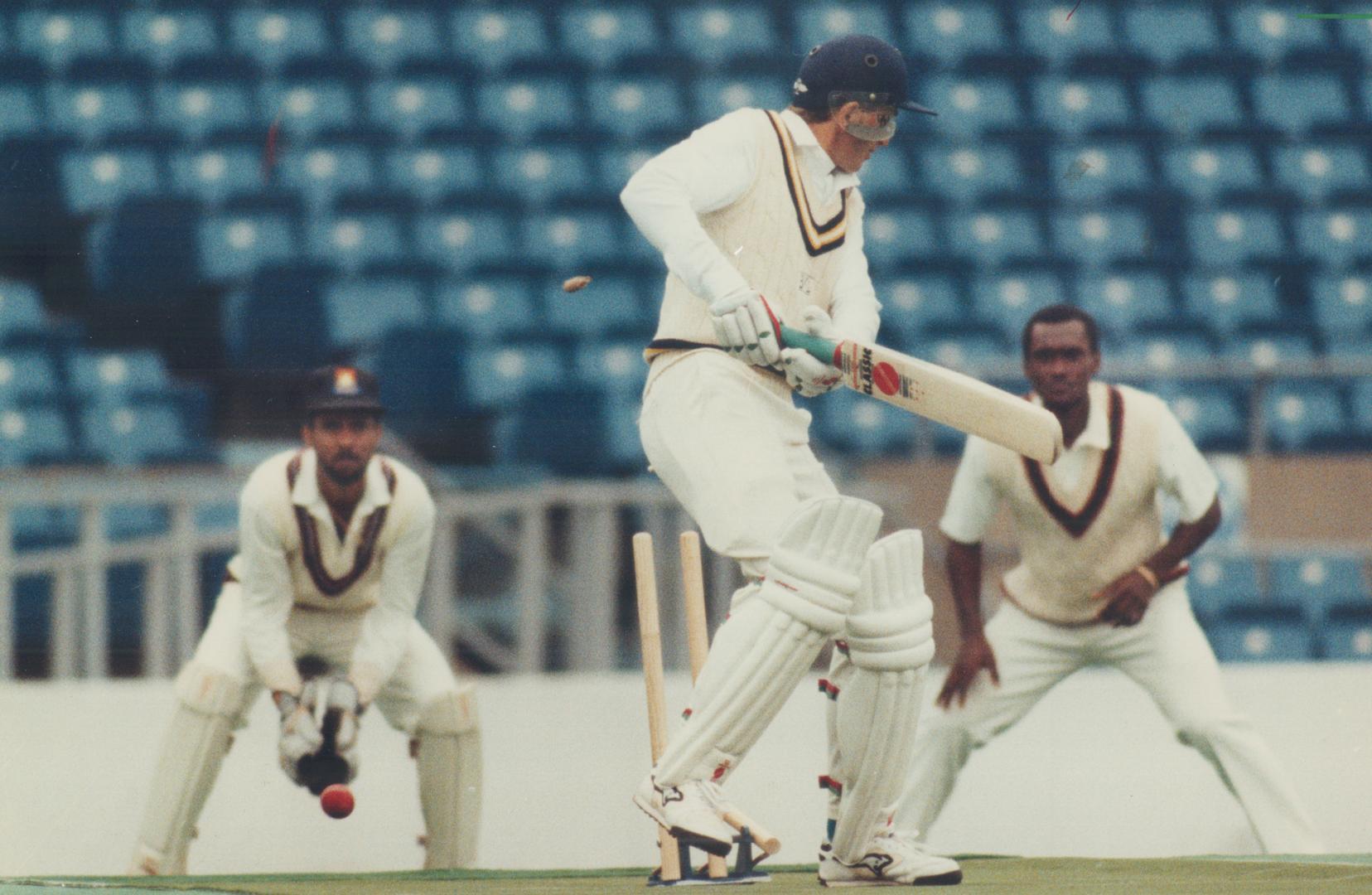 England's Test star David Gower has his off stump up-rooted by West Indian paceman Ian Bishop at Exhibition Stadium yesterday as wicketkeeper Peter Dujon and Carl Hooper look on