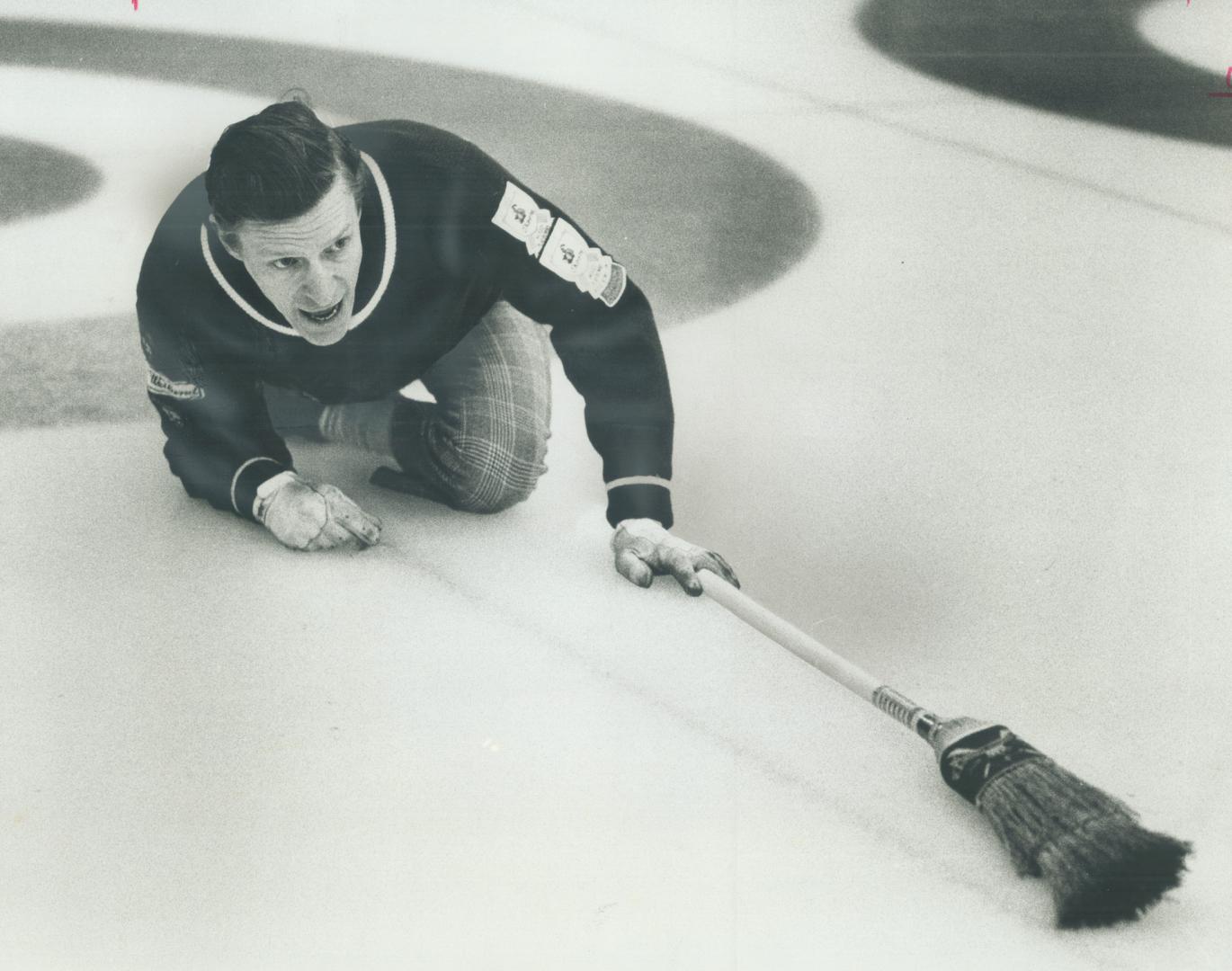 Shouting commands to his sweepers as rock slides down ice is Leaside skip Paul Weiland