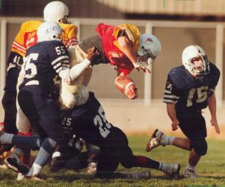 Panther on the fly. Victoria Park ball carrier Nick Foutris stretches for a touchdown while being hauled down by Central Tech's No. 55, Clint Vassel, (...)