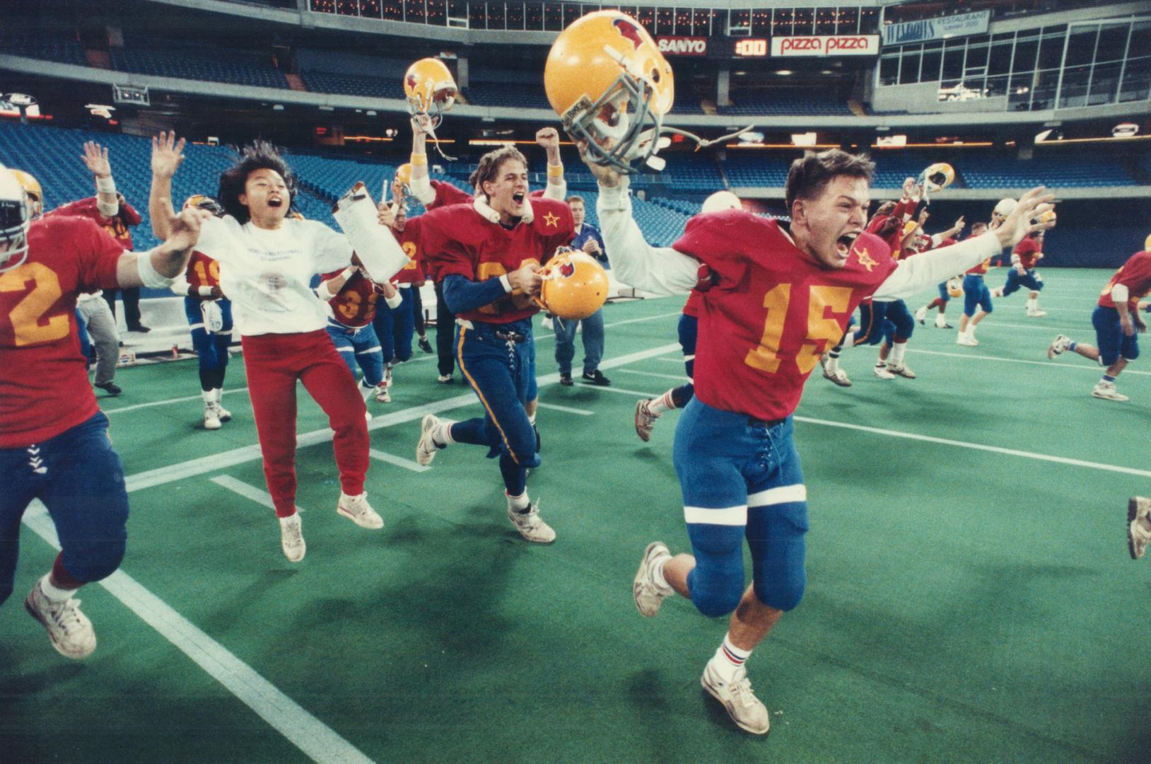 Charge! Northern's Dan Gana (15) leads the victory celebration after the Red Knights squeezed out a 14-11 win over Markham Marauders in the Metro Bowl(...)