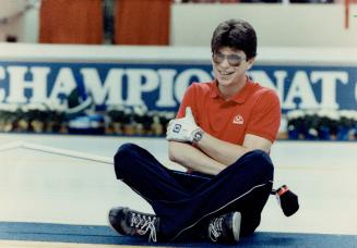 Unorthodox pose: Newfoundland lead Dave Warren, 21, takes time out for a rest and a chukle during yesterday's action at Labatt Brier, at Kitchener Memorial Audittorium