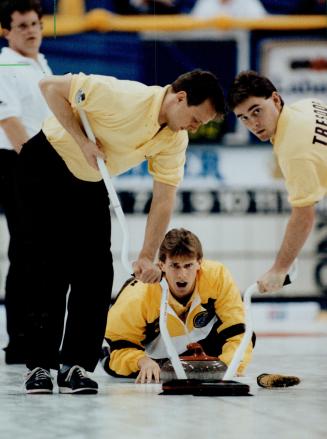 Looks good: Manitoba skip Jeff Stoughton turns his rock over to Ken Tressor, right, and Gary Vandenbeghe, yesterday at the Brier