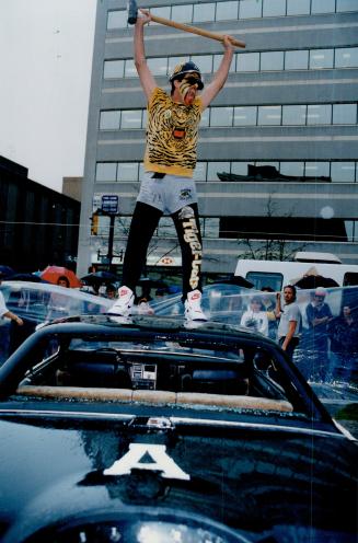 Argo Basher: Tiger-cat fan smashes an Argo car (for charity) at pep rally