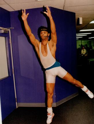 Steven Wilson demonstrates the moves to his class in white Lycra bodysuit and turquoise battery pack