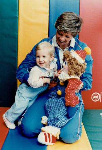 Tyke fitness hits Mississauga. Kristel Gobby, 14 months, and mom Helen meet puppet Gymbo at an open house at the New Mississauga headquarters of Gymbo(...)