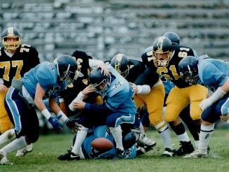 Fumbling around: Two St. Michael's Blues close in on ball after their team fumbled against Pocock Pirates in high school quarterfinal