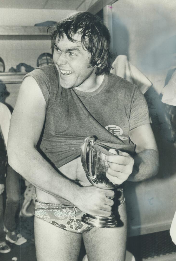 Half a cup's better. During dressing-room hijinks after his team's 20-13 victory over Montreal Alouettes, Edmonton Eskimo centre Ted Milian tries to h(...)