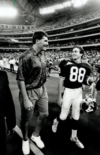 Game talk: Mark Ryplen, left, talks with Argo Paul Masotti, who would be on the receiving end of Ryplen's passes should the disgruntied Redskin come north