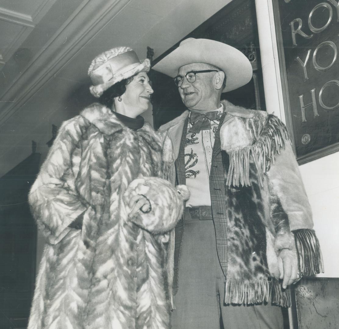 Ready to liven things up, Calgary Stampeder fans Marj Allen, a Calgary real estate agent, stands beside Calgary tycoon Bill Herron, planning festivities