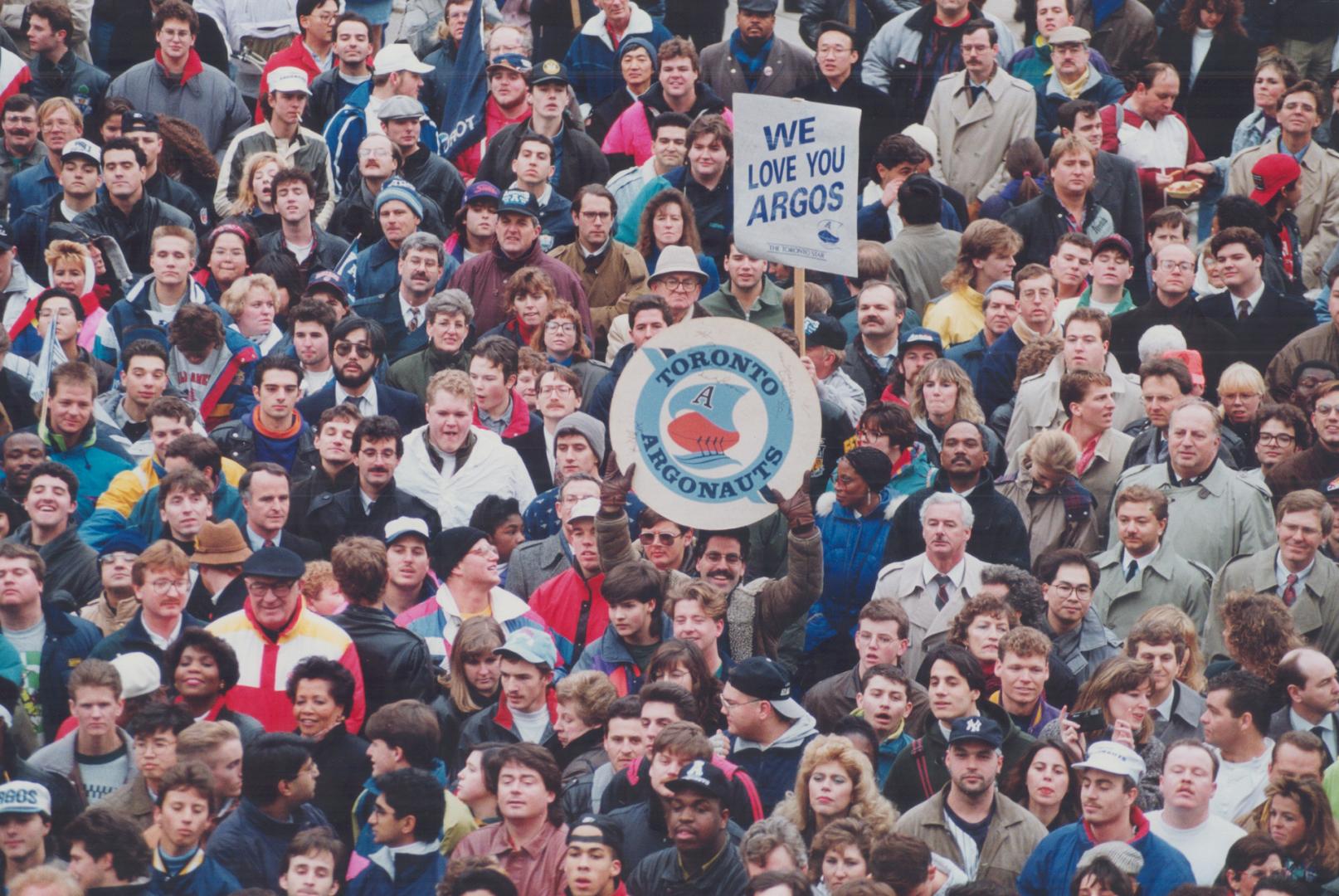 Face of Victory: It's a mob scene at Toronto City Hall yesterday as 20,000 Argo fans cheer the team's Grey Cup triumph over Calgary