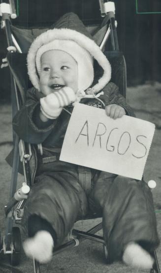 Ardent fan: Even at 11 months, Seth Veenstra knows who he's rooting for - and he's certainly dressed for the cold stands at the big game