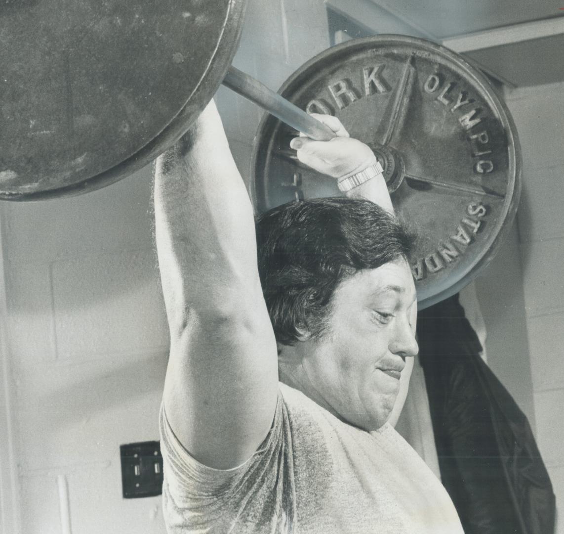 It's a cinch! Lamar Leachman, Argos' new assistant coach who can lift 360 pounds, has no difficulty in raising weight at workout in Bloor St. YMHA yes(...)