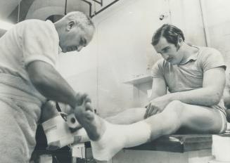 Tape by the yard is used by Argonaut trainer Mert Prophet as he prepares his charges for Grey Cup clash with Calgary Stampeders Sunday at Vancouver. H(...)