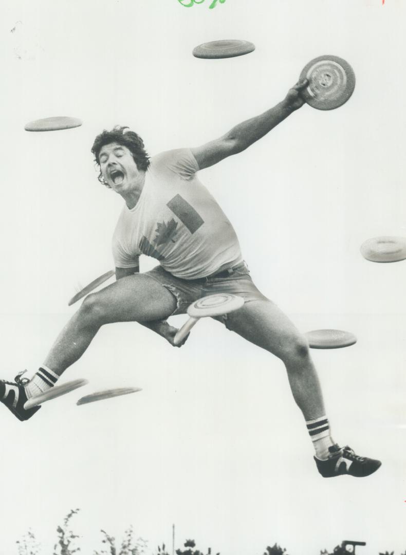 Sharpening up his reflexes for the Canadian Open Frisbee Tournament at Harborfront this weekend, 20-year-old Ron Seabourne has his hands full trying t(...)