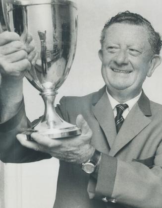 Champion and Trophy: Scarborough's Phil Farley displays Shaughnessy Trophy which he won yesterday in Canadian Seniors Trophy which he won yesterday in Canadian Seniors Golf Association championship