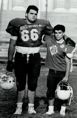 Twins? No, just teammates. All-star lineman Belchior Arruda and his little buddy, rookie outside linebacker Joe Fonseca, go arm in arm into battle for Central Tech