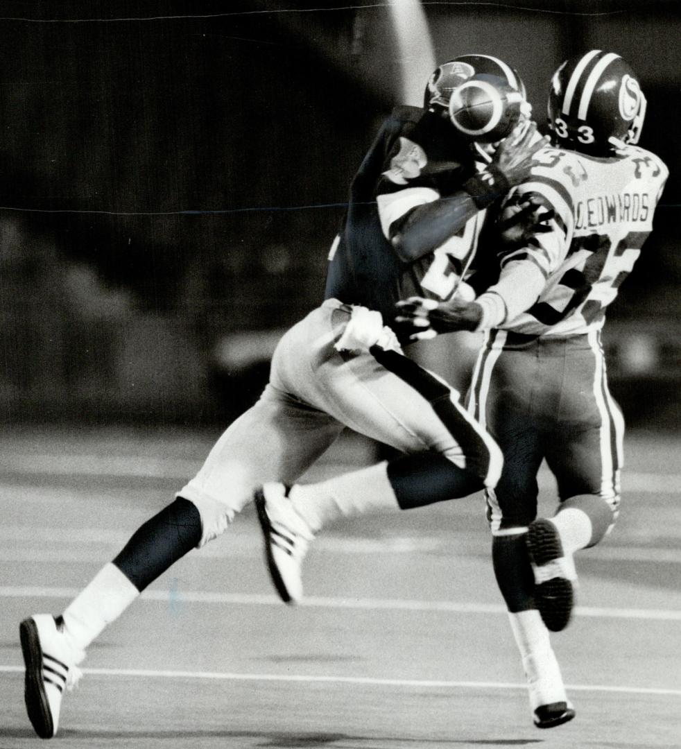 Argos' Marcellus Greene, left, fights for ball with Roughriders' Dwight Edwards, a former Argo, and Greene comes up with it for an interception with one-handed juggling act