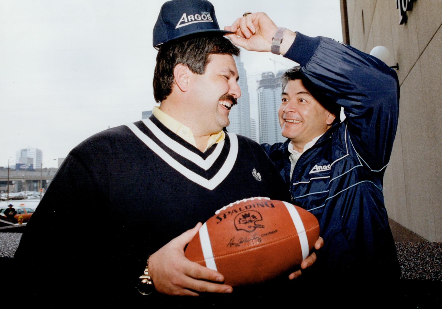 Argo aide: Bruce Cowdrey, Argonauts' new offensive line coach from Purdue, gets capped by head coach Adam Rita yesterday