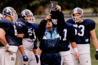 Toronto argonauts line coach Tony Marciano with members of offensiveline