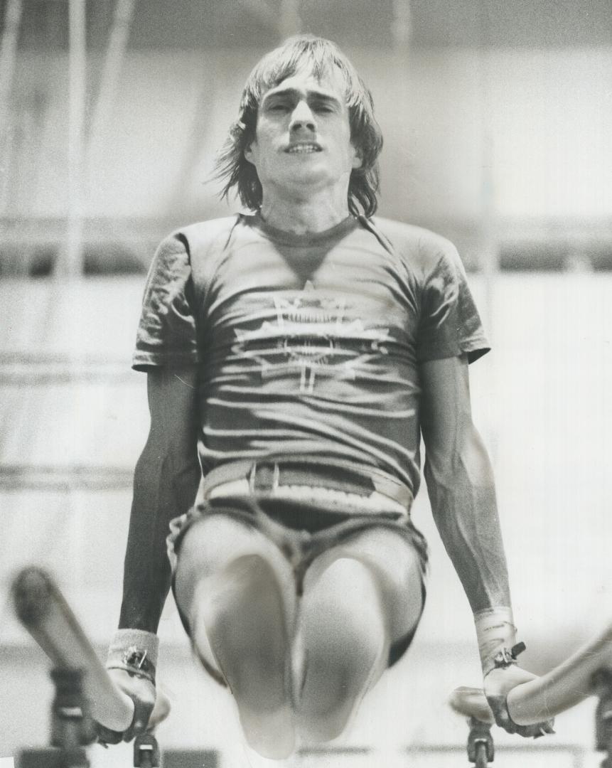 Strain shows. Canadian collegiate gymnastics champion Steve Maclean of York University grimaces as he practices for Saturday's competition against Pen(...)