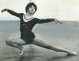 Demonstrating her gymnastic grace, Julie Wideman, with coach Alex Bard, practises 23 hours a week