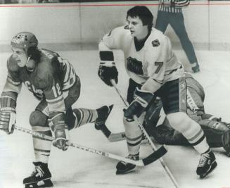 Bill Barber gives Sergei Starikov a shot, establishing his position in front of Soviet net