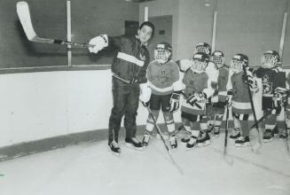 Role model, Former Metro Toronto Housing Authority resident Jason Cirone, now a player in the Italian Hockey League, helps coach a group of Metro Juni(...)