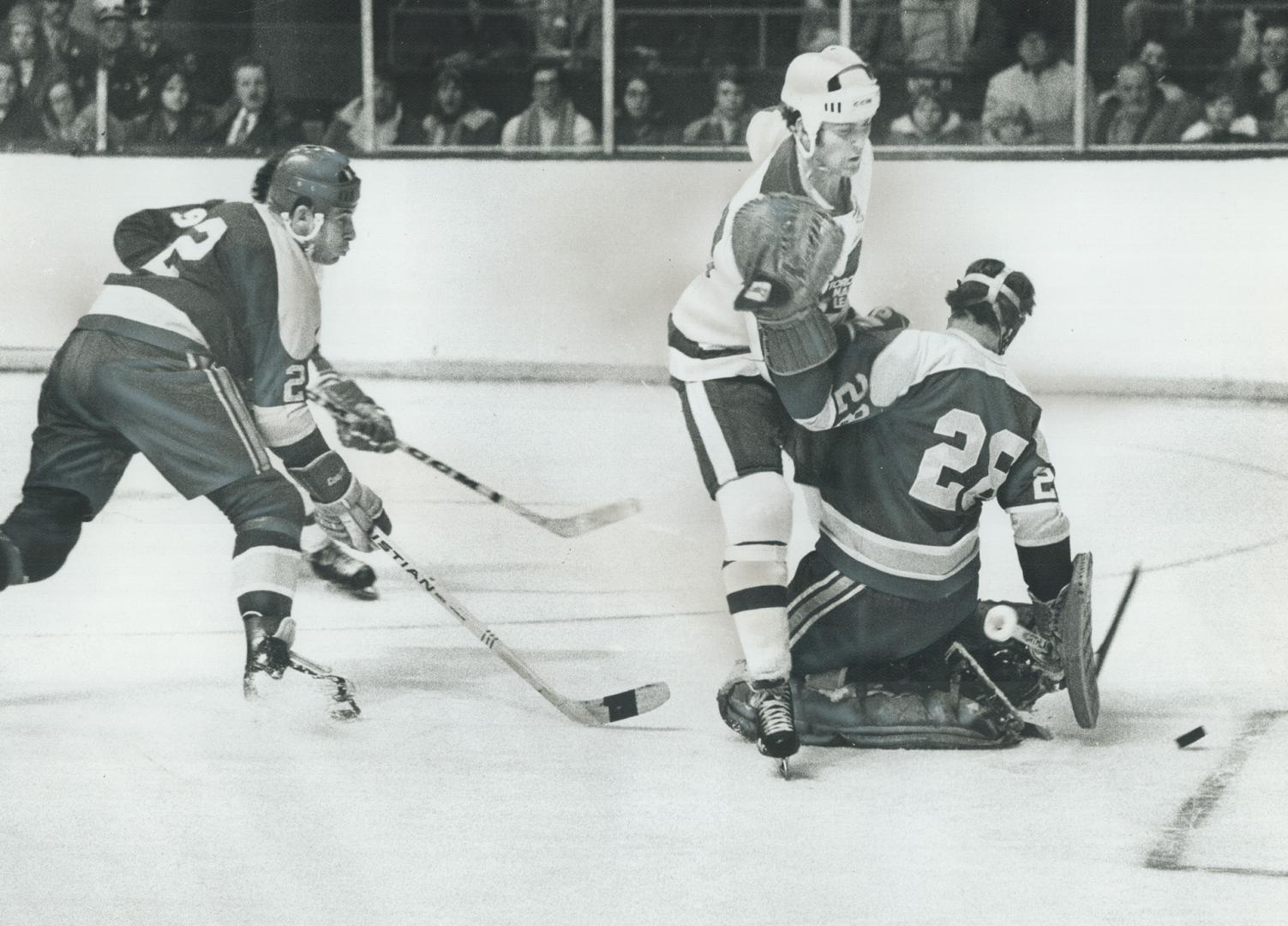 A Pair Of Sticks, including that of California Seals' Marshall Johnston (2), seems to be path through which Paul Henderson of Leafs has skated to scor(...)