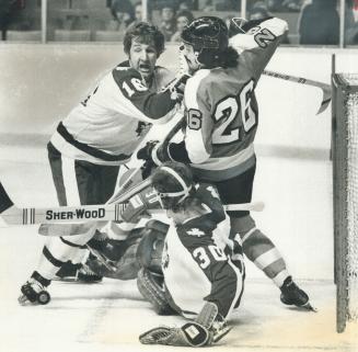 Oh No, You Don't - Leaf defenceman Rod Seiling (16) does an admirable job of keeping Philadelphia (26) awaty from the puck as it bounces right in fron(...)