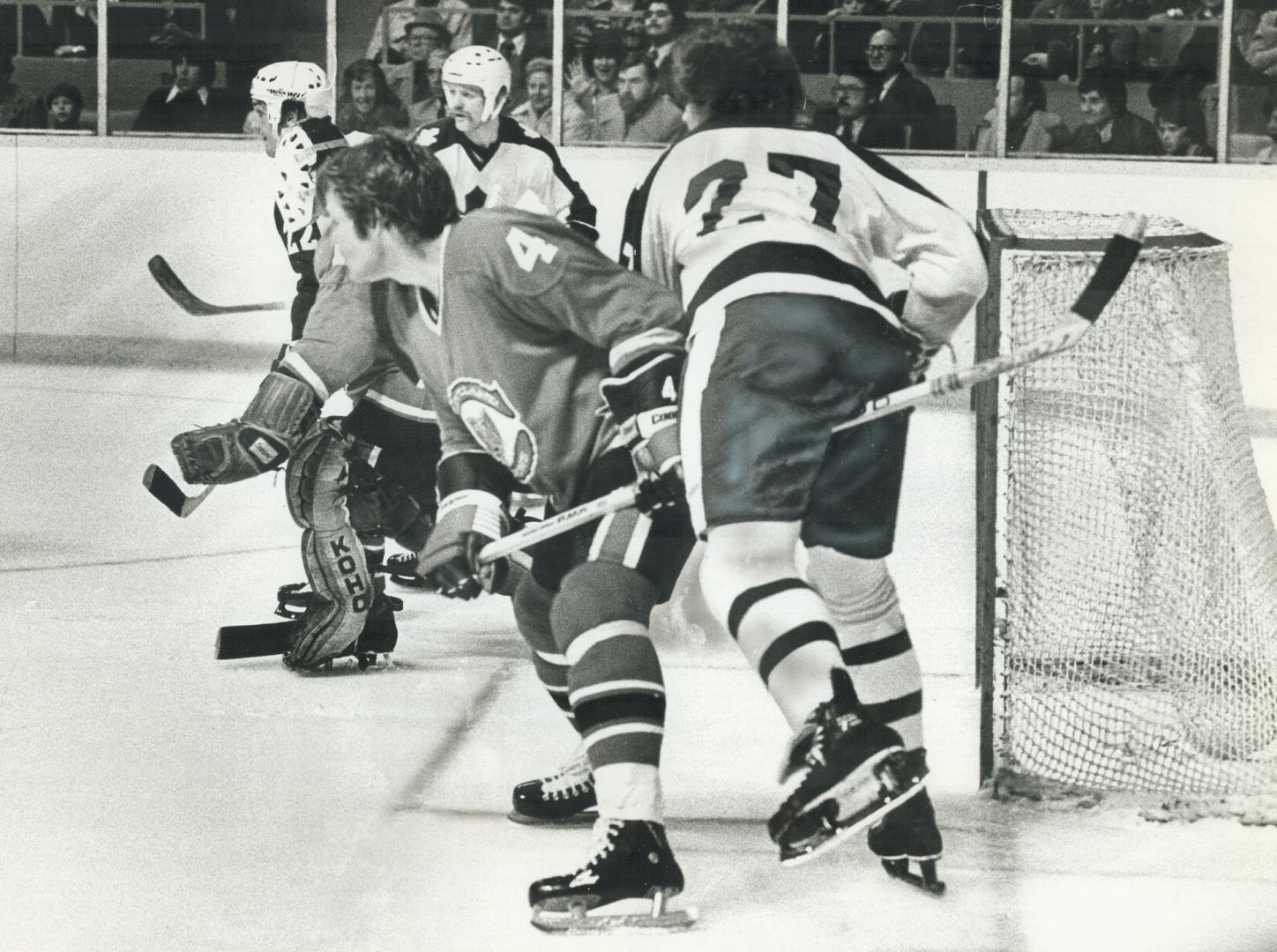 Oops! Pardon me, Darryl. Leafs' Sittler (27) meets Barons' Bob Stewart