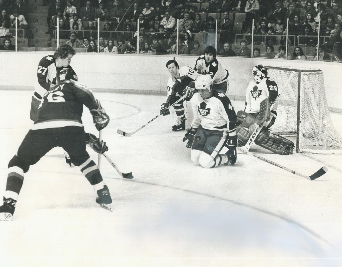 Maple Leaf goaltender Mike Palmateer gets some help from defenceman Trevor Johansen, on knees, at Maple Leaf Gardens