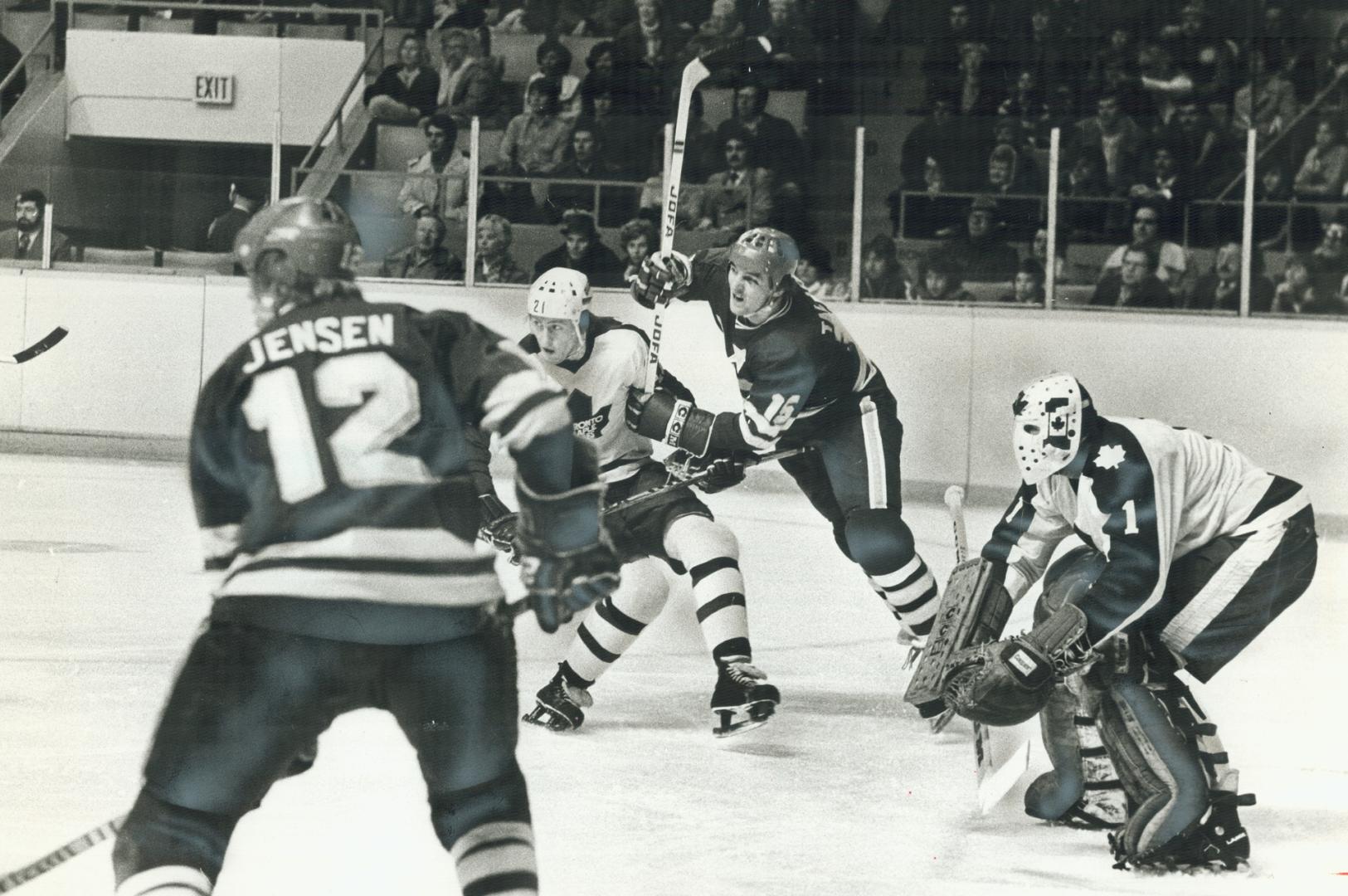 Gord McRae gets set for a drive from the point as Leaf's Borje Salming (21) fends off Stars' Dean Talafous