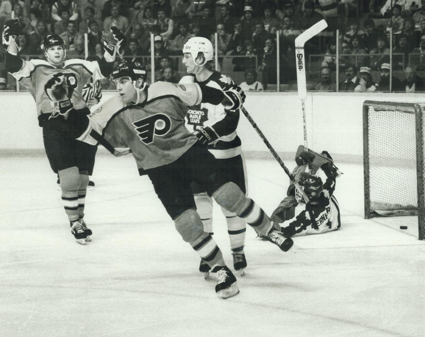 Enough is enough! Rick Tocchet of the Philadelphia Flyers skates away from the net and goalie Tim Bernhardt sprawls after Tocchet made it 6-0 in en em(...)