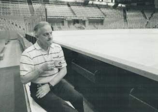 Loneliness is: Leafs trainer Danny Lemelin, who normally doesn't stop working on game day, sits alone yesterday in an empty arena