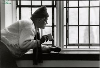 In the warm: John, who has been on the street for two years, enjoys a hot drink and a glance at the outside world after lunch at Metropolitan United Church