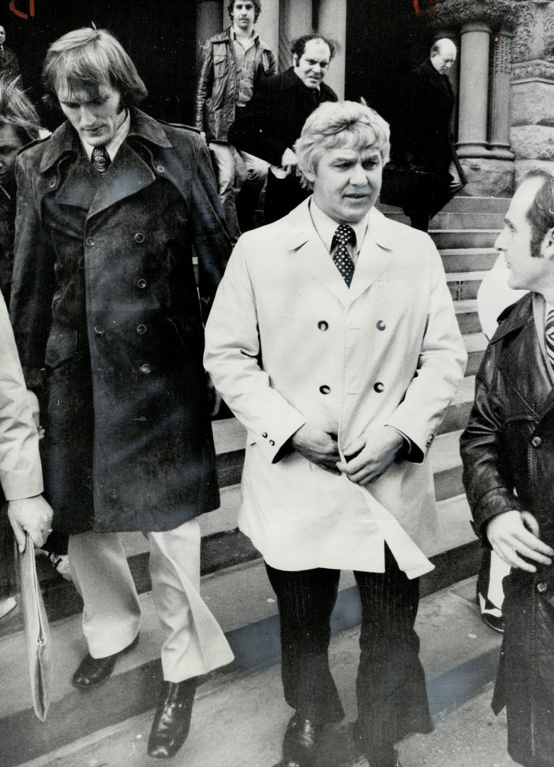 Dan Maloney of Detroit Red Wings (left) leaves old city hall courthouse with Alex Delvecchio, team's general manager