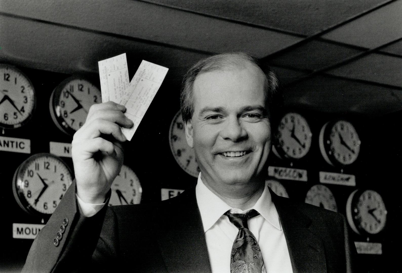 A good news bearer. Peter Mansbridge, the anchor on CBC-TV's the National, holds high two tickets to a Blue Jays game he won when his name was drawn in this week's Star Ball contest draw