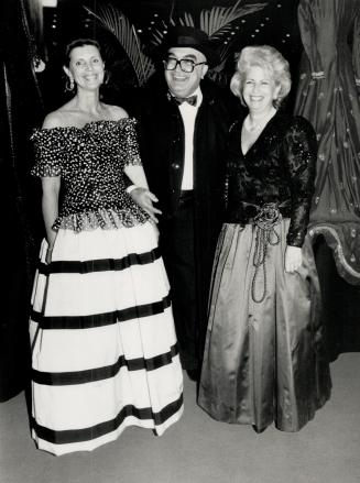 Greeting Lotfi Mansouri who came in black cape and hat, are gala chairman Shari Fell, left, and Carole Grafstein, right, who is wearing a purple Brian Winstown gown