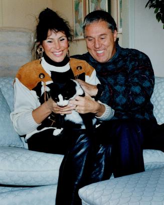 So long, Argos. Don Matthews, here huddling at home with wife Catherine and cat Sam, resigned yesterday after a single season as Argonauts coach