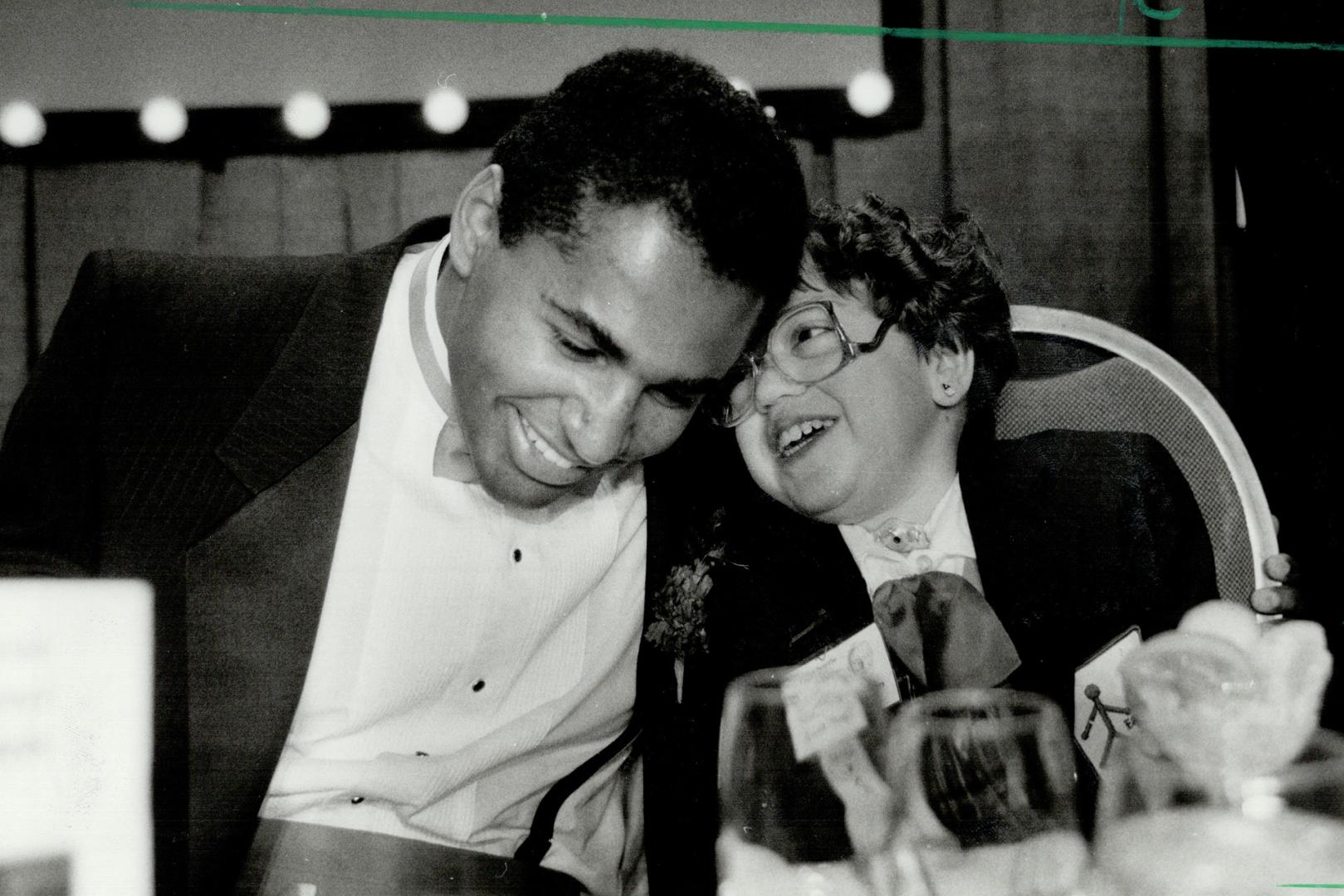 Rueben Mayes, National Football League rookie of the year, shares a laugh with Jennifer Thompson, 14, of Mississauga, this year's Easter Seals Society(...)