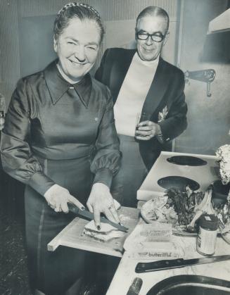 Picture of Pauline McGibbon, Lieutenant-Governor-designate, fixing sandwich for her husband, should have been matched by a picture of Premier Bill Davis putting out garbage, reader says below