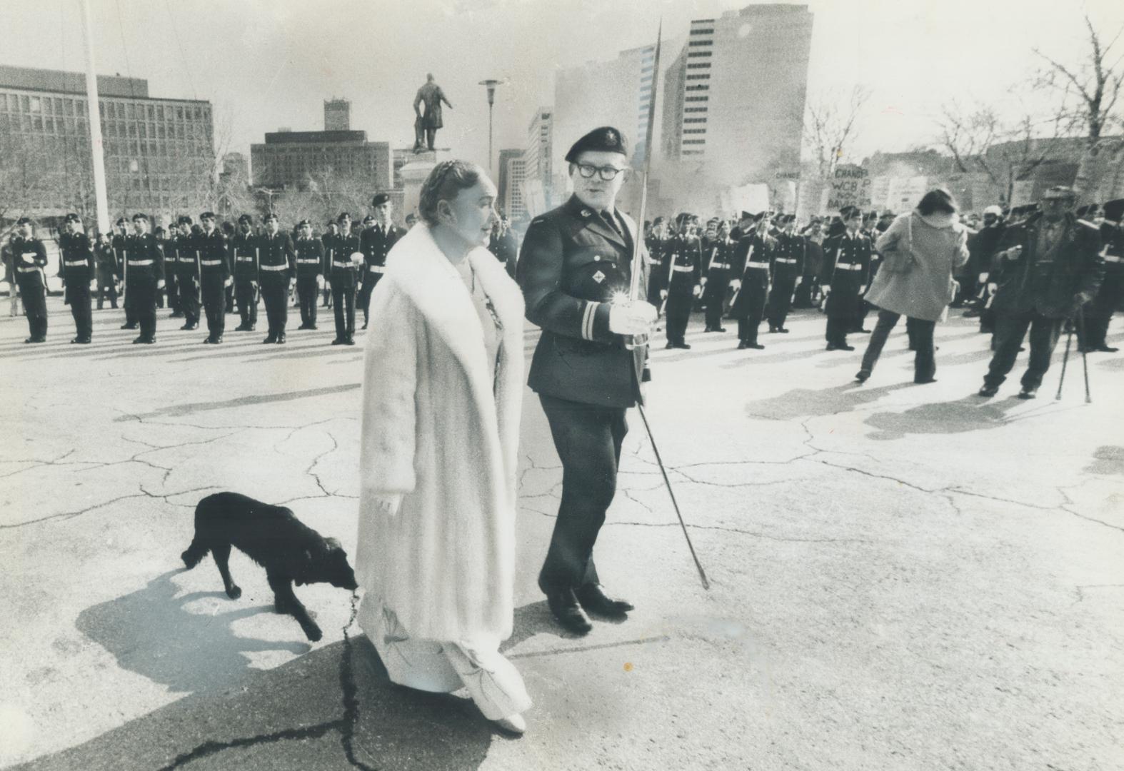 A wandering black dog trots in the footsteps of Lieutenant-Governor Pauline McGibbon yesterday as she returned to the dais outside Queen's Park after (...)