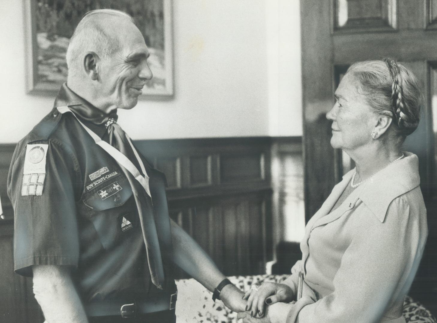 Jim Melling, 57-year-old East York man who spent past 45 years working with Boy Scouts, is presented with outstanding service award yesterday by Lieut(...)