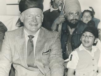 Police deputy wears a new hat. Deputy Police Chief William McCormack dons a makeshift turban yesterday to attend Baisakhi Day celebrations at the Sikh(...)