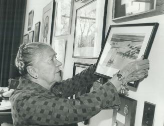 It all ends (right) as Mrs. McGibbon takes favorite photos down from her wall at Queen's Park