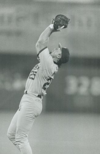 Ups and downs: Pat Borders hits a sky-high pop at the SkyDome last night that was caught by Oakland A's first baseman Mark McGwire